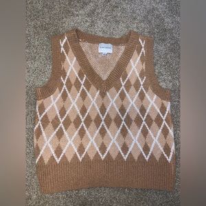 Brown and white cropped sweater vest.